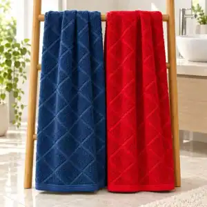 Full-size blue and red bamboo bath towels with an angled woven cross design hanging in a bathroom