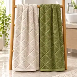 Full-size macadamia and olive bamboo bath towels with an angled woven cross design hanging in a bathroom
