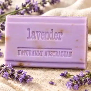 Purple Clover Fields lavender soap bar displayed with lavender flowers