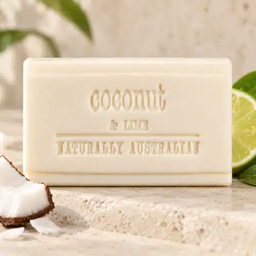 Clover Fields Coconut & Lime soap bar displayed with coconut and sliced lime