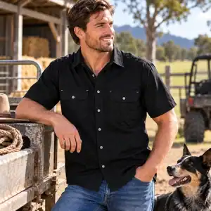 Man wearing Dundee black short sleeve bamboo work shirt on a rural property