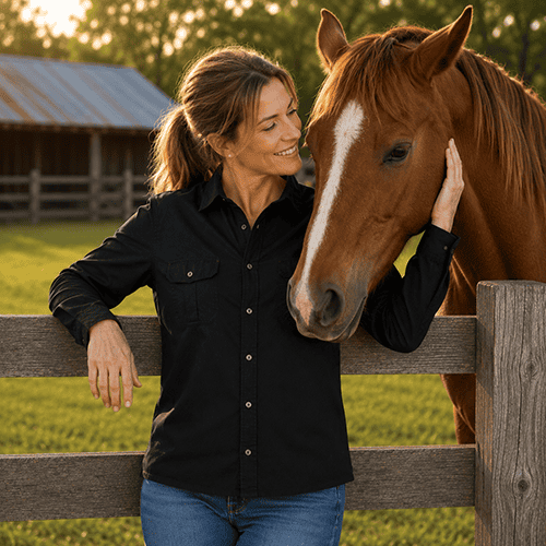 Woman wearing Dundee unisex bamboo work shirt beside horse on farm